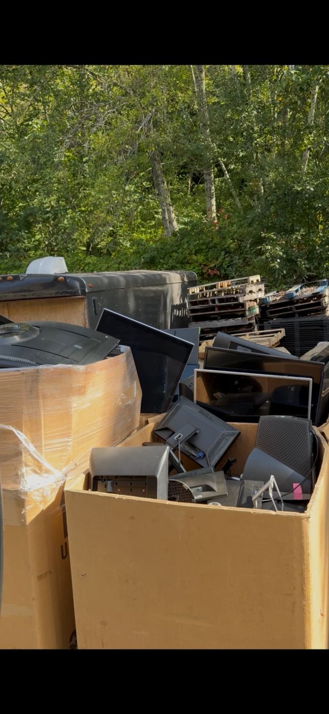 Pile of old monitors and electronics sorted for recycling in Edmonds
