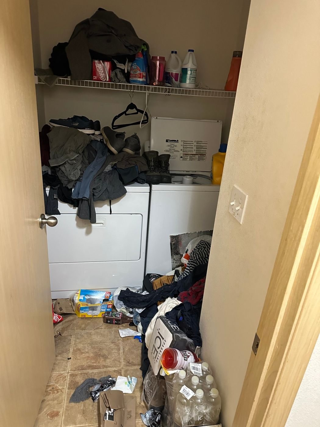 Cluttered laundry closet before appliance pickup in Edmonds