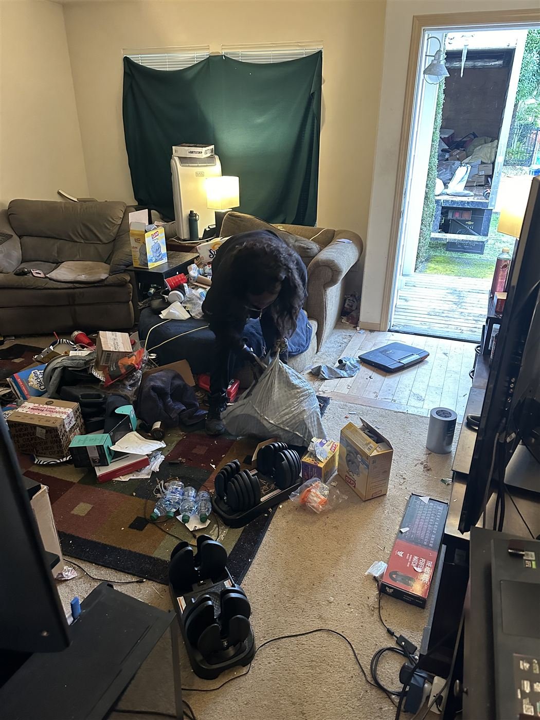 Living room full of clutter before pickup