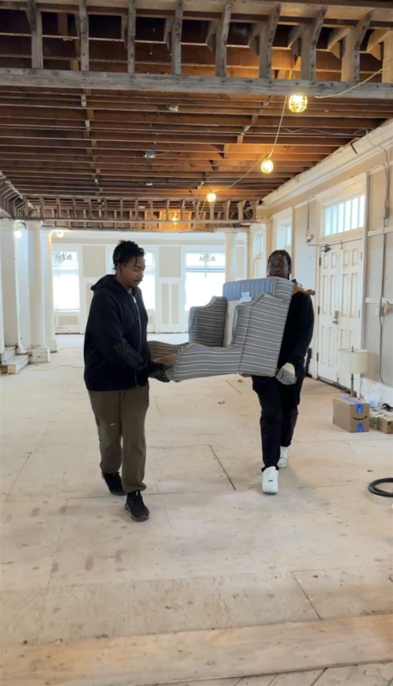 Crew carrying a couch out for pickup