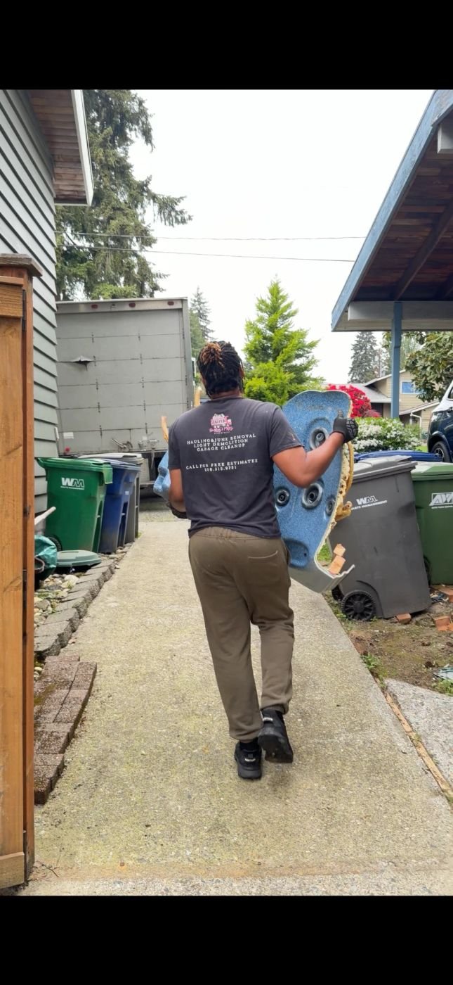 Crew carrying a hot tub panel out for hauling in Edmonds