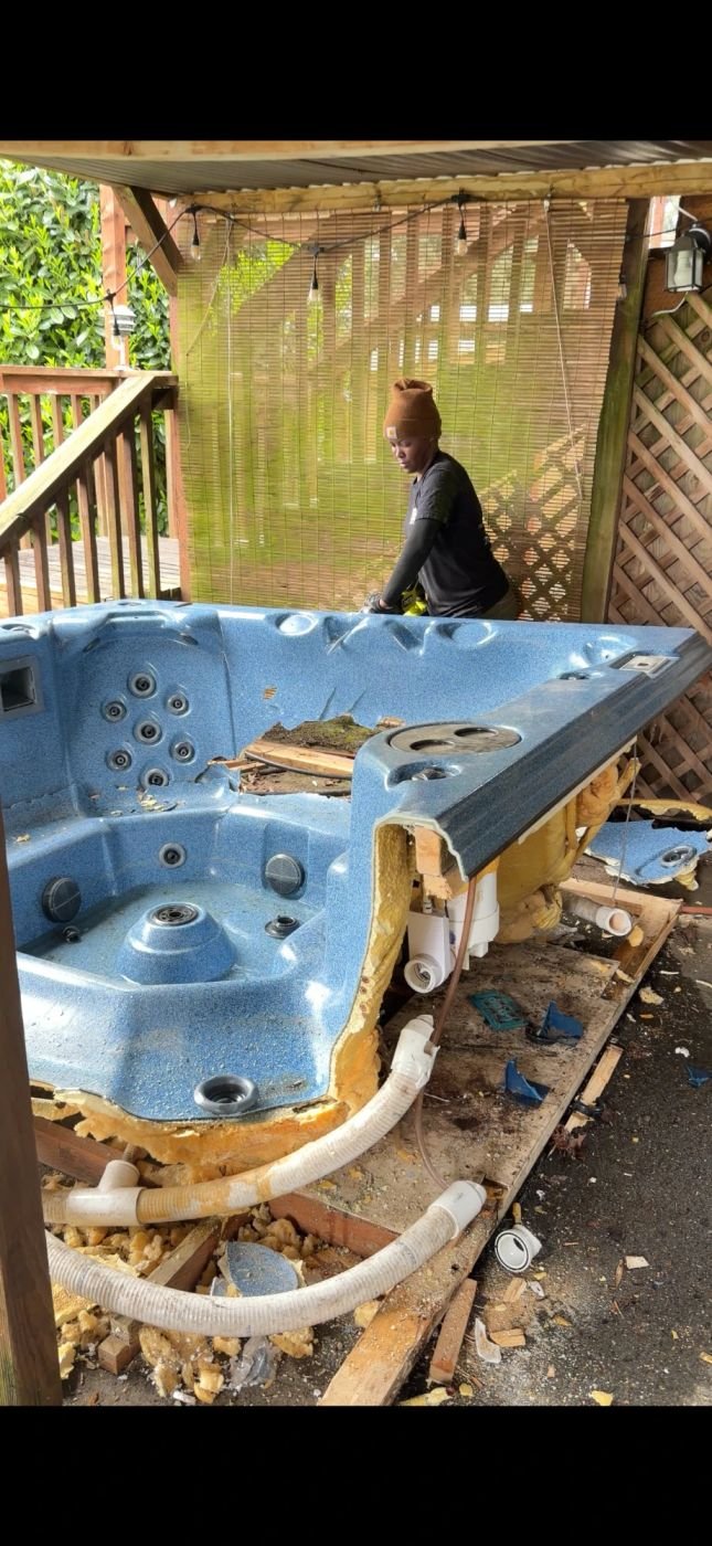 Smiles 4 Miles crew next to a dismantled hot tub shell in Kent